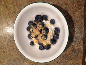 A bowl of flaxseed, blueberries and yoghurt