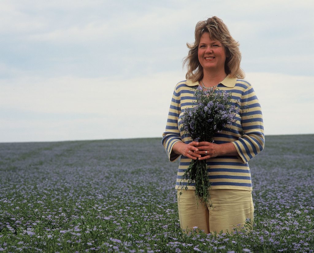 Esther Hylden, the Flax Lady, in blooming flax